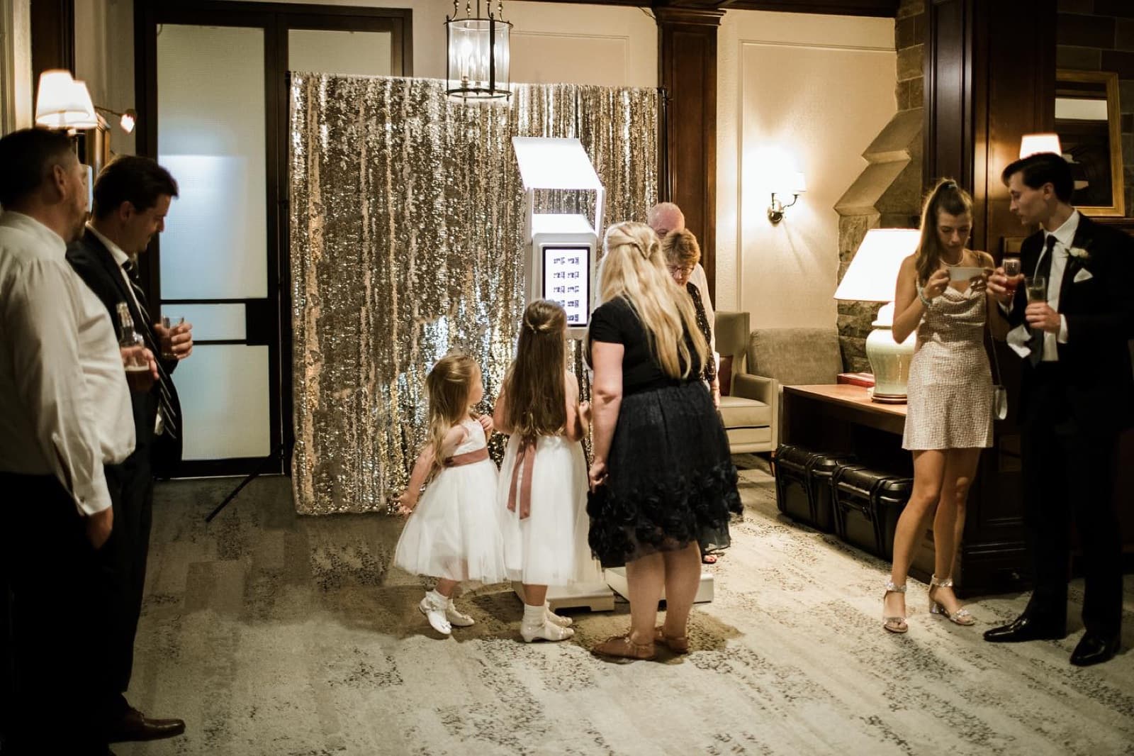 The booth set up in a wedding reception room with guests waiting their turn